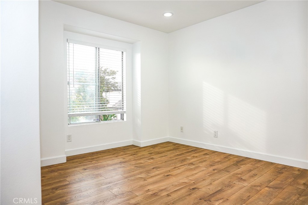 13142 Windsor Lane Garden Grove, CA 92843 - Photo 16 of 24 a view of empty room with wooden floor and fan