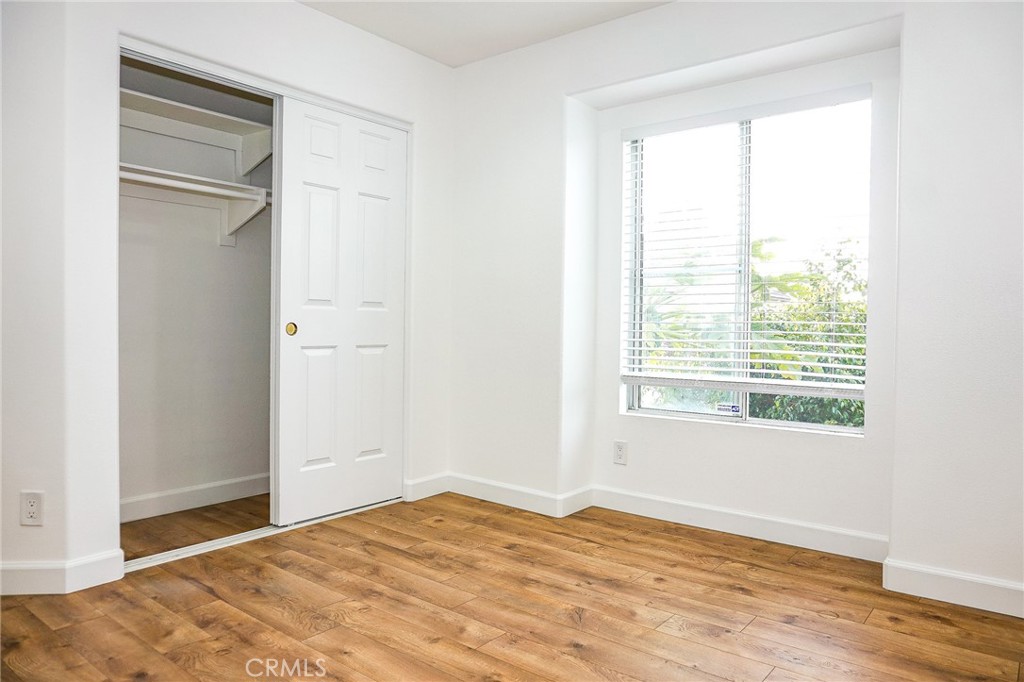 13142 Windsor Lane Garden Grove, CA 92843 - Photo 17 of 24 a view of an empty room with wooden floor and a window