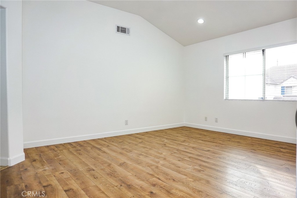 13142 Windsor Lane Garden Grove, CA 92843 - Photo 20 of 24 an empty room with wooden floor and windows