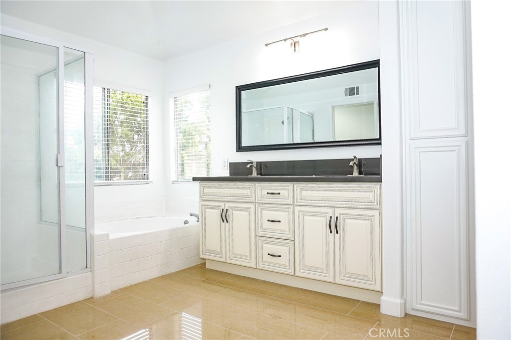13142 Windsor Lane Garden Grove, CA 92843 - Photo 22 of 24 a bathroom with a granite countertop sink and a mirror