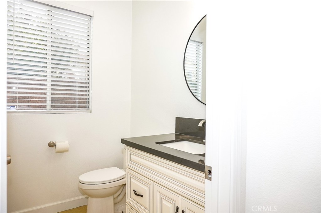 13142 Windsor Lane Garden Grove, CA 92843 - Photo 7 of 24 a bathroom with a sink a toilet and a mirror