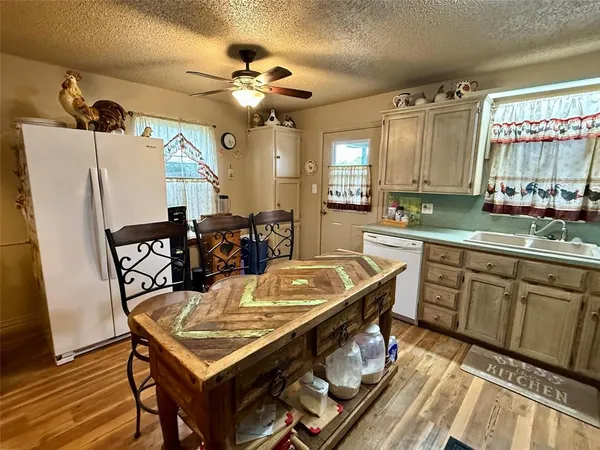a kitchen with stainless steel appliances granite countertop a sink a stove and refrigerator