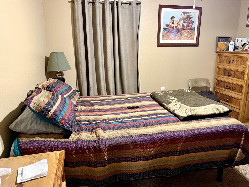 555 South Allen Street Boyd, TX 76023 - Photo 10 of 14 a bedroom with a bed and a painting on the wall