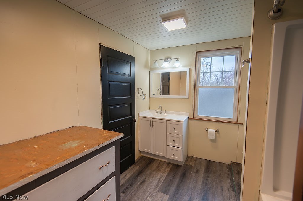 1195 South Johnson Road Sebring, OH 44672 - Photo 23 of 34 Bathroom featuring vanity, dark wood finished floors, and wooden ceiling