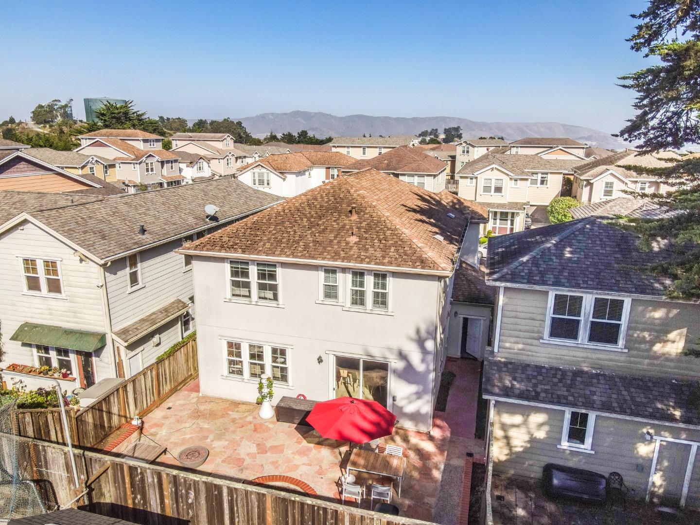 117 Cypress Street Pacifica, CA 94044 - Photo 30 of 40 a view of a white house with a yard and potted plants