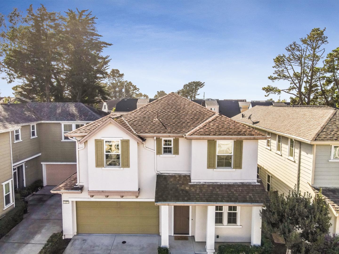 117 Cypress Street Pacifica, CA 94044 - Photo 3 of 40 a view of a white house next to a yard with large trees