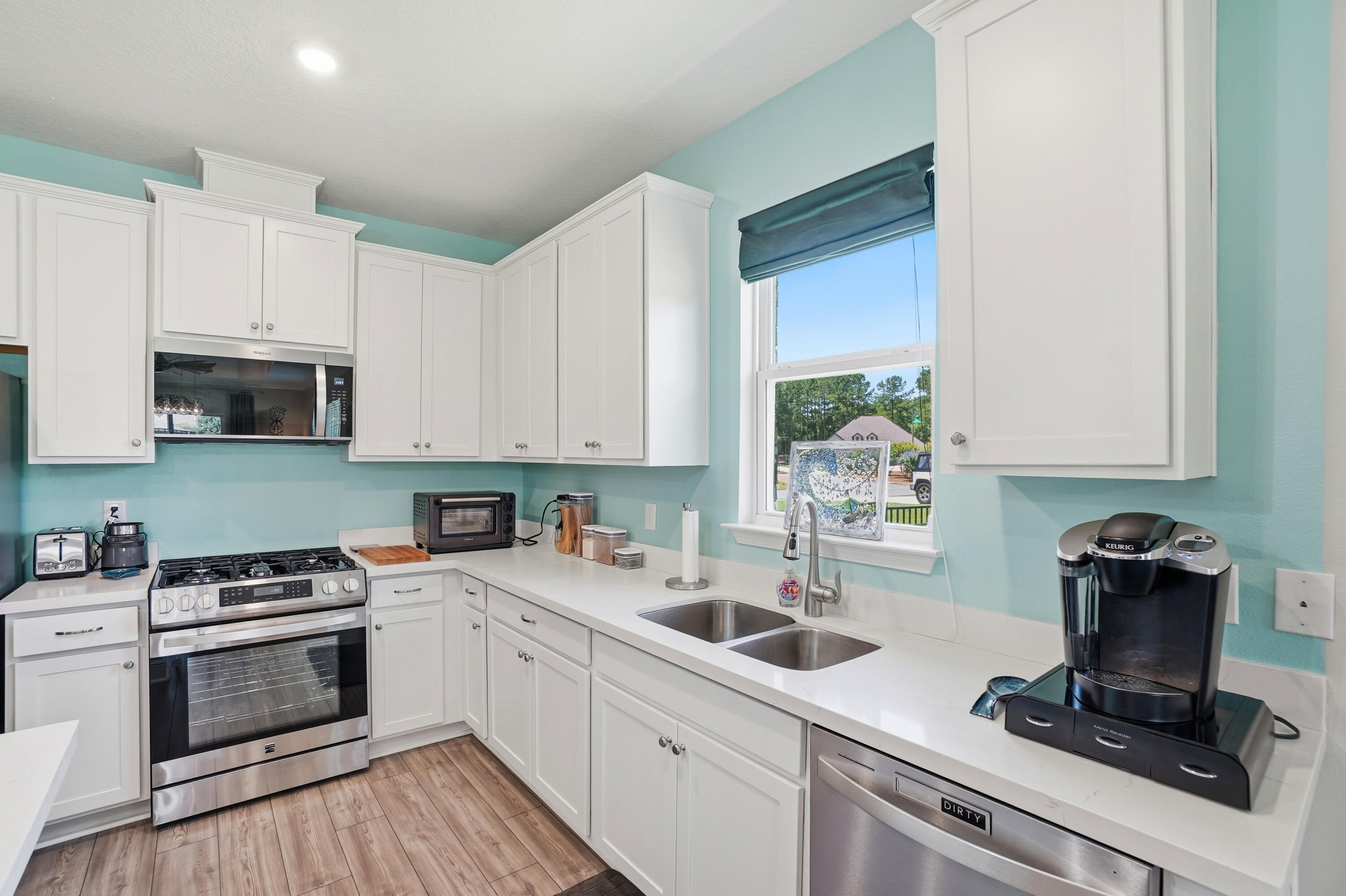525 Windchime Way Freeport, FL 32439 - Photo 10 of 59 a kitchen with appliances a sink and cabinets
