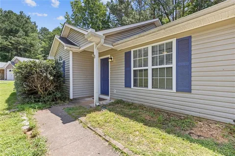 a view of house with backyard and garden