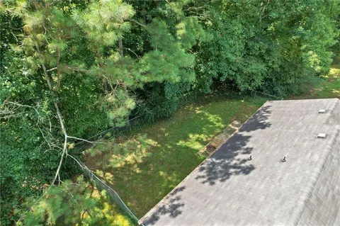 a yard with large trees