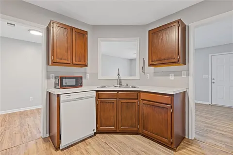 a kitchen with stainless steel appliances granite countertop a sink and cabinets