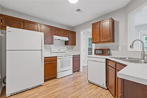 a kitchen with a refrigerator sink and stove