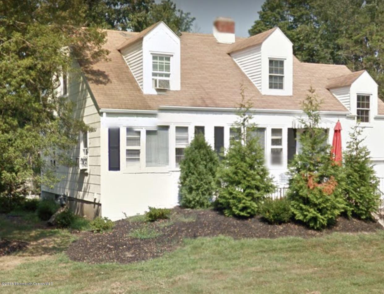 716 Shore Road Spring Lake Heights, NJ 07762 - Photo 1 of 7 a front view of a house with a yard garage and outdoor seating