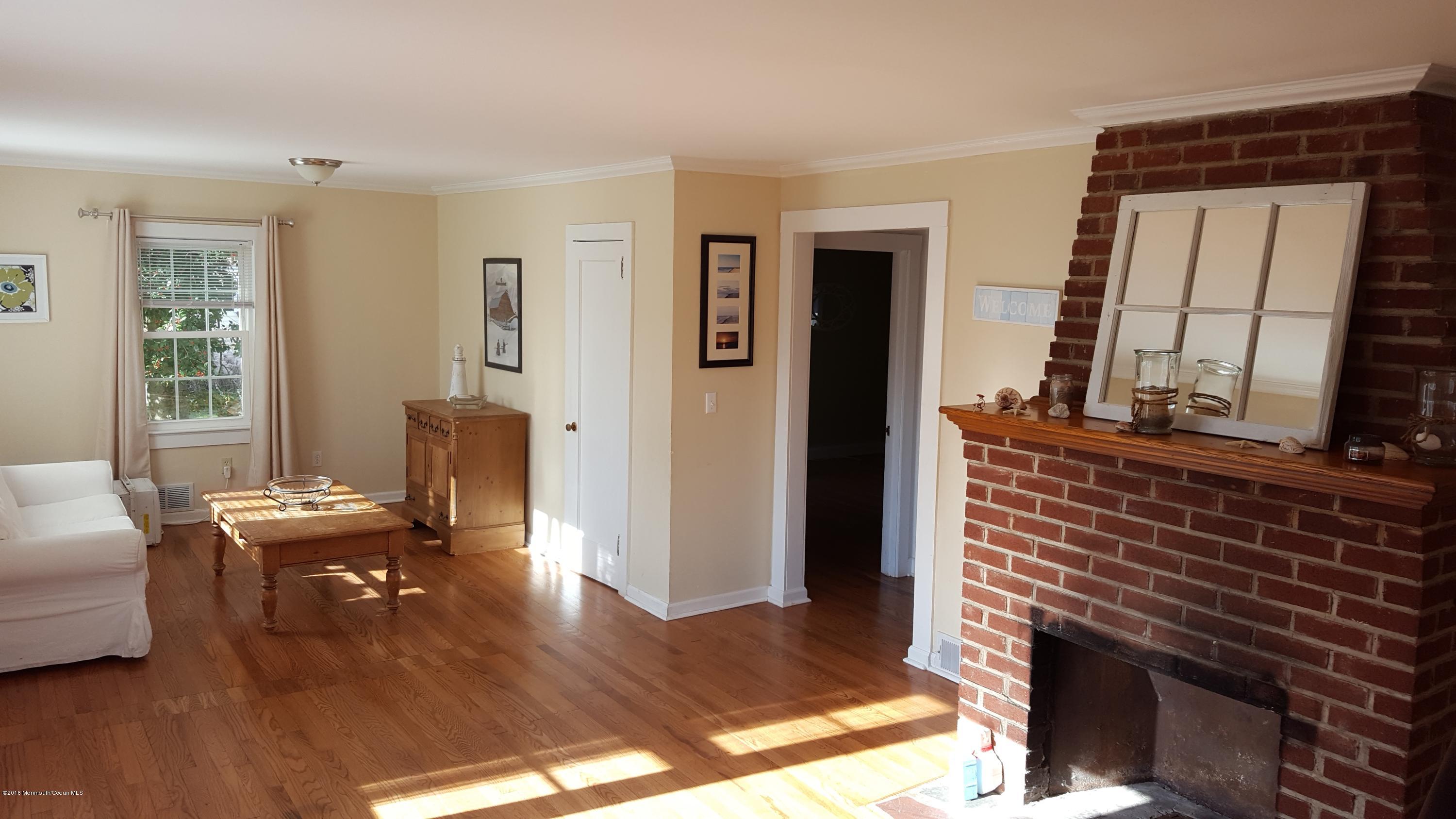 716 Shore Road Spring Lake Heights, NJ 07762 - Photo 2 of 7 a living room with furniture and a fireplace