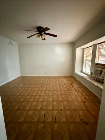 a view of a room with a empty space and a window