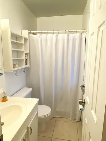 a bathroom with a sink toilet and mirror