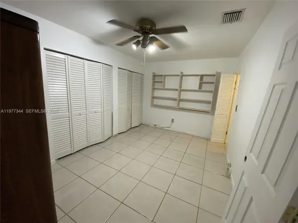 a kitchen with a sink a counter top space cabinets and stainless steel appliances