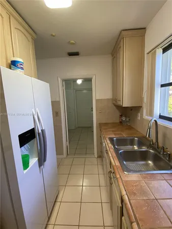 a utility room with wooden floor washer and dryer