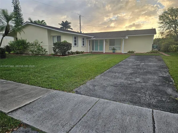 a front view of house with yard and green space