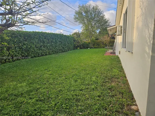 a view of yard from a corridor
