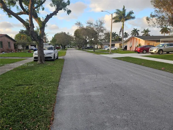 a view of street with parked cars