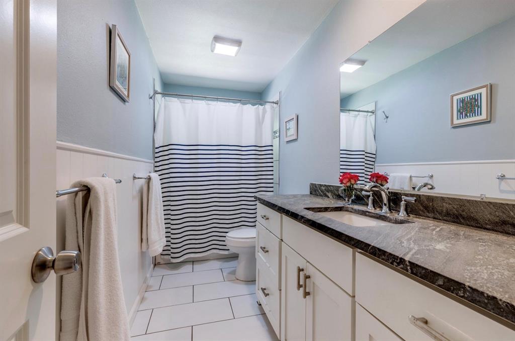 3605 Merrell Road Dallas, TX 75229 - Photo 12 of 25 a bathroom with a sink and a mirror