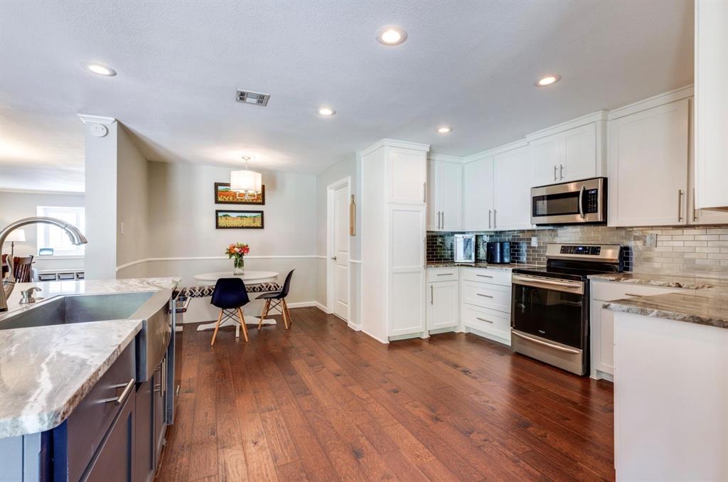 3605 Merrell Road Dallas, TX 75229 - Photo 15 of 25 a kitchen with a sink white cabinets and stainless steel appliances
