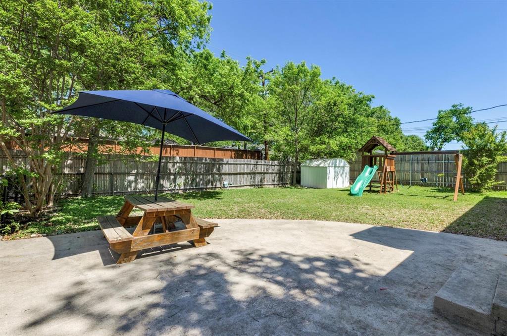 3605 Merrell Road Dallas, TX 75229 - Photo 4 of 25 a view of backyard with a table and chairs under an umbrella
