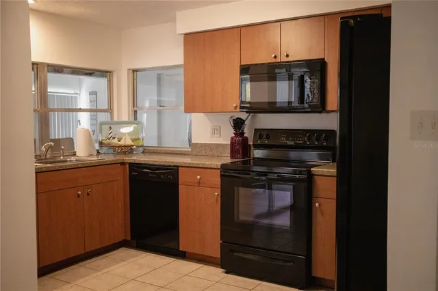a kitchen with stainless steel appliances granite countertop a stove and a microwave
