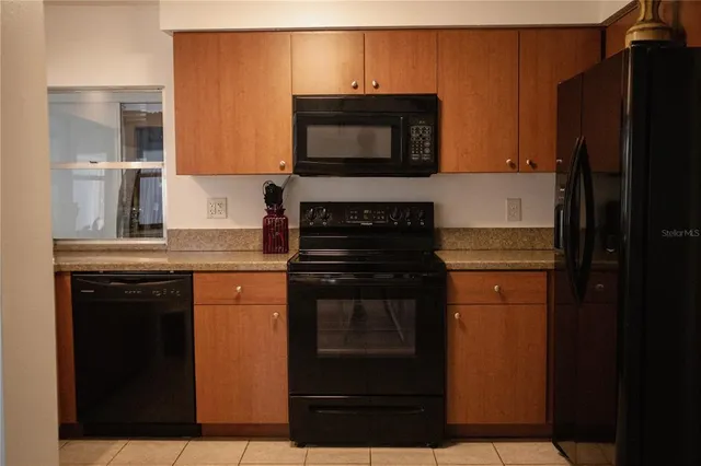 a kitchen with granite countertop a stove and a microwave