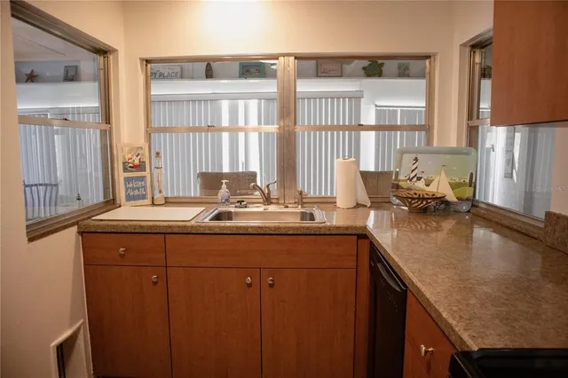 a kitchen with stainless steel appliances granite countertop a sink and a cabinets