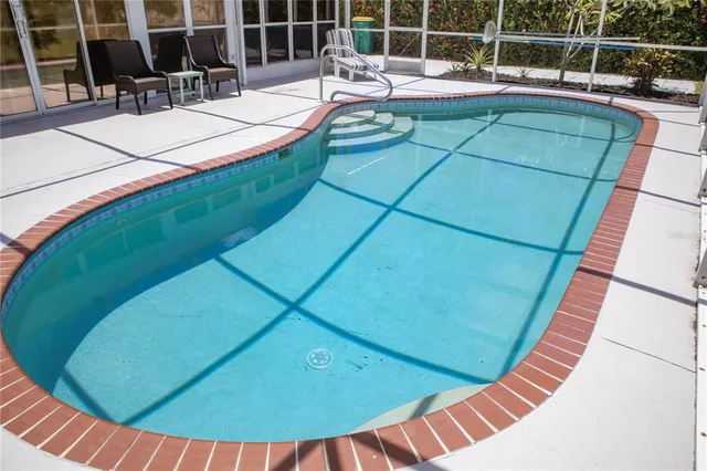 a view of a swimming pool with a patio
