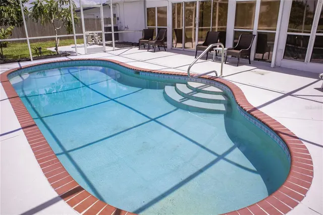 a view of swimming pool with outdoor seating