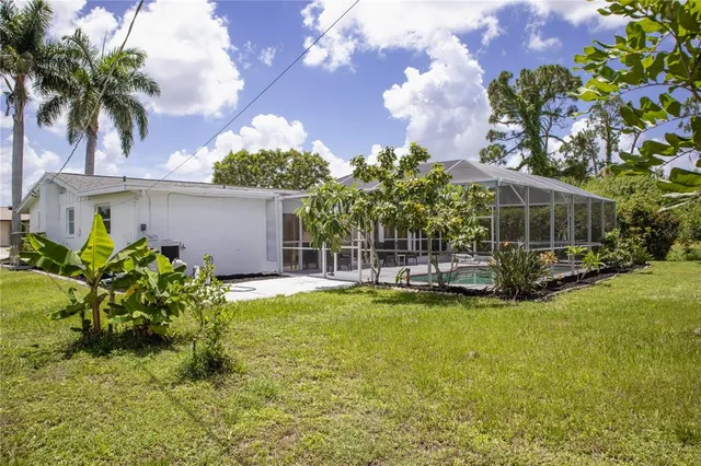 a view of a house with swimming pool and sitting area