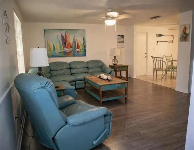 a living room with furniture and wooden floor