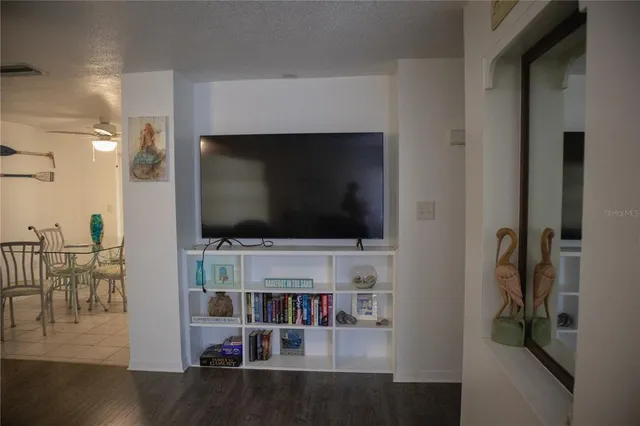 a living room with flat screen tv and furniture