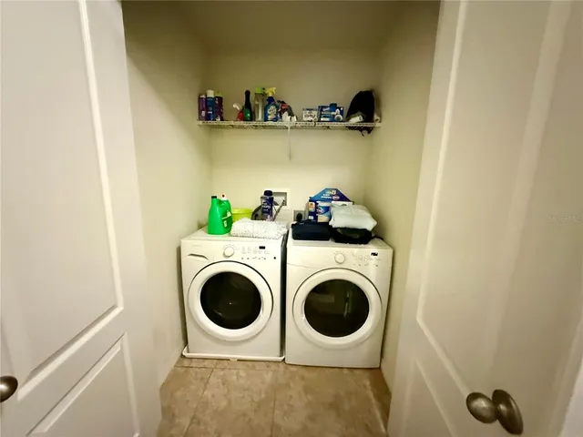 a view of walk in closet with clothes