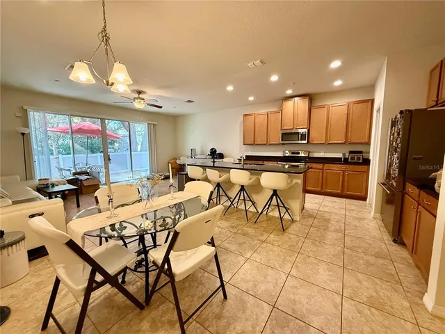 a kitchen with stainless steel appliances kitchen island granite countertop a sink and cabinets