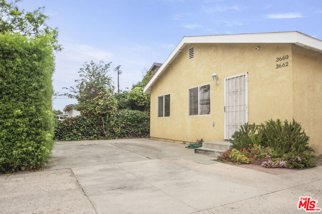 3660 Halldale Avenue Los Angeles, CA 90018 - Photo 2 of 10 a front view of a house with a garden
