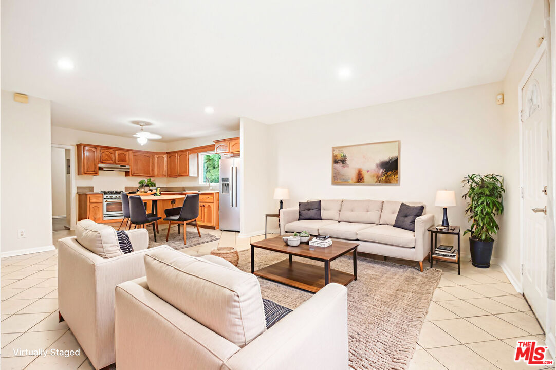 3660 Halldale Avenue Los Angeles, CA 90018 - Photo 4 of 10 a living room with furniture and view of kitchen