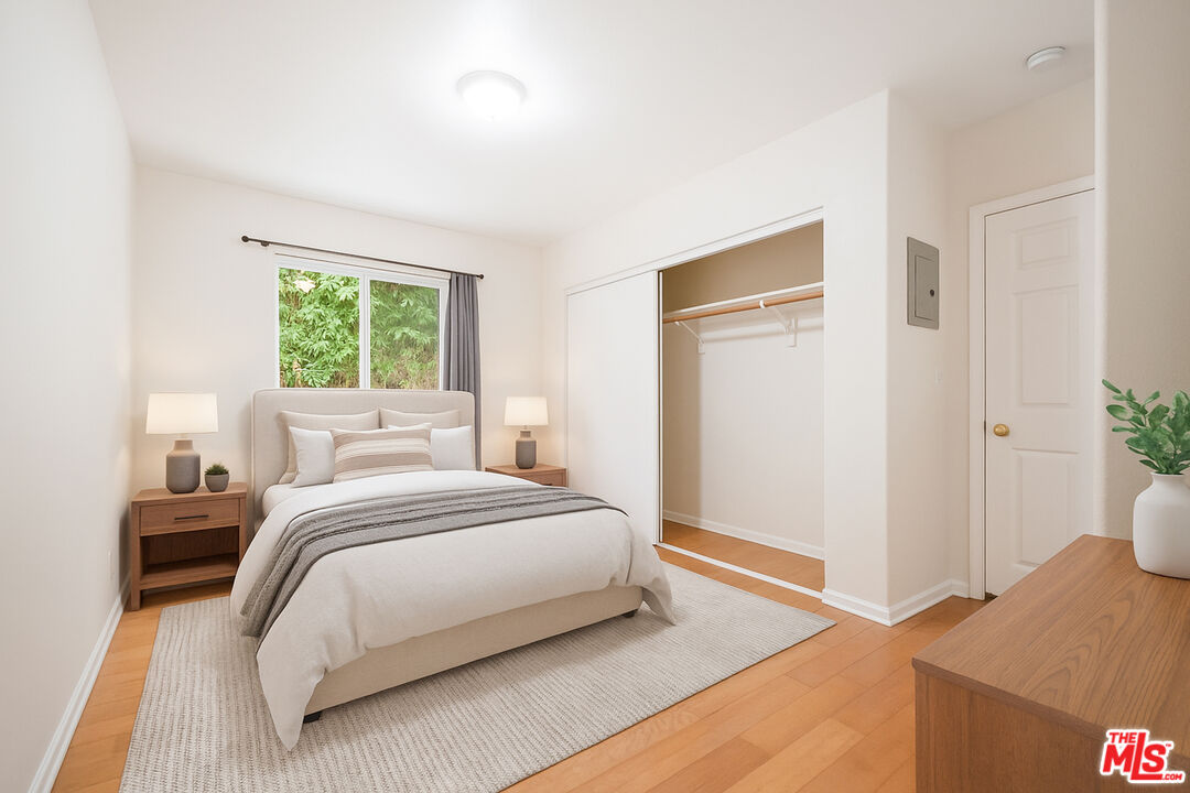 3660 Halldale Avenue Los Angeles, CA 90018 - Photo 9 of 10 a bedroom with a bed and a potted plant