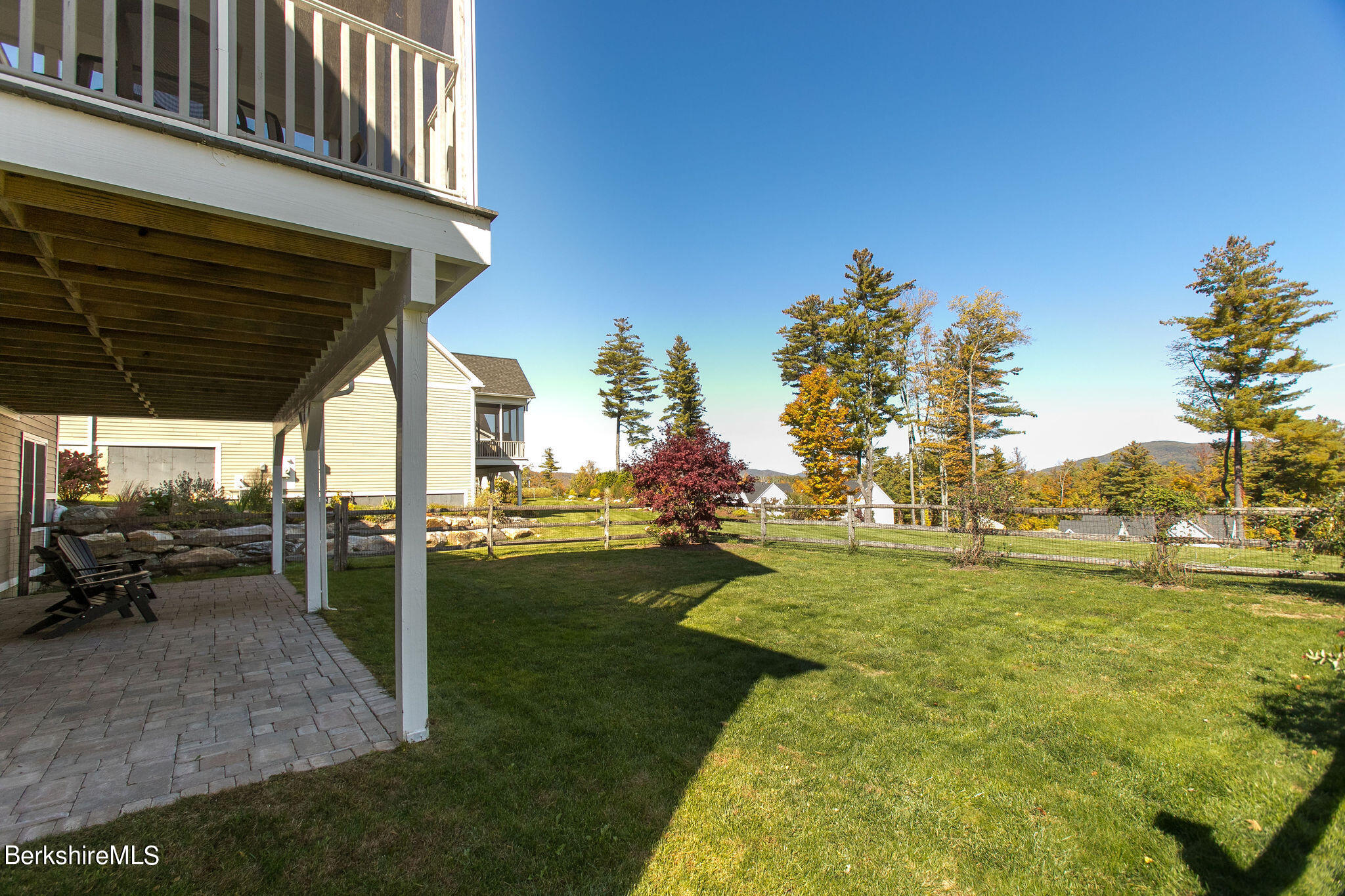 19 Burning Tree Road Great Barrington, MA 01230 - Photo 4 of 33 a view of a patio with a table and chairs under an umbrella with a yard