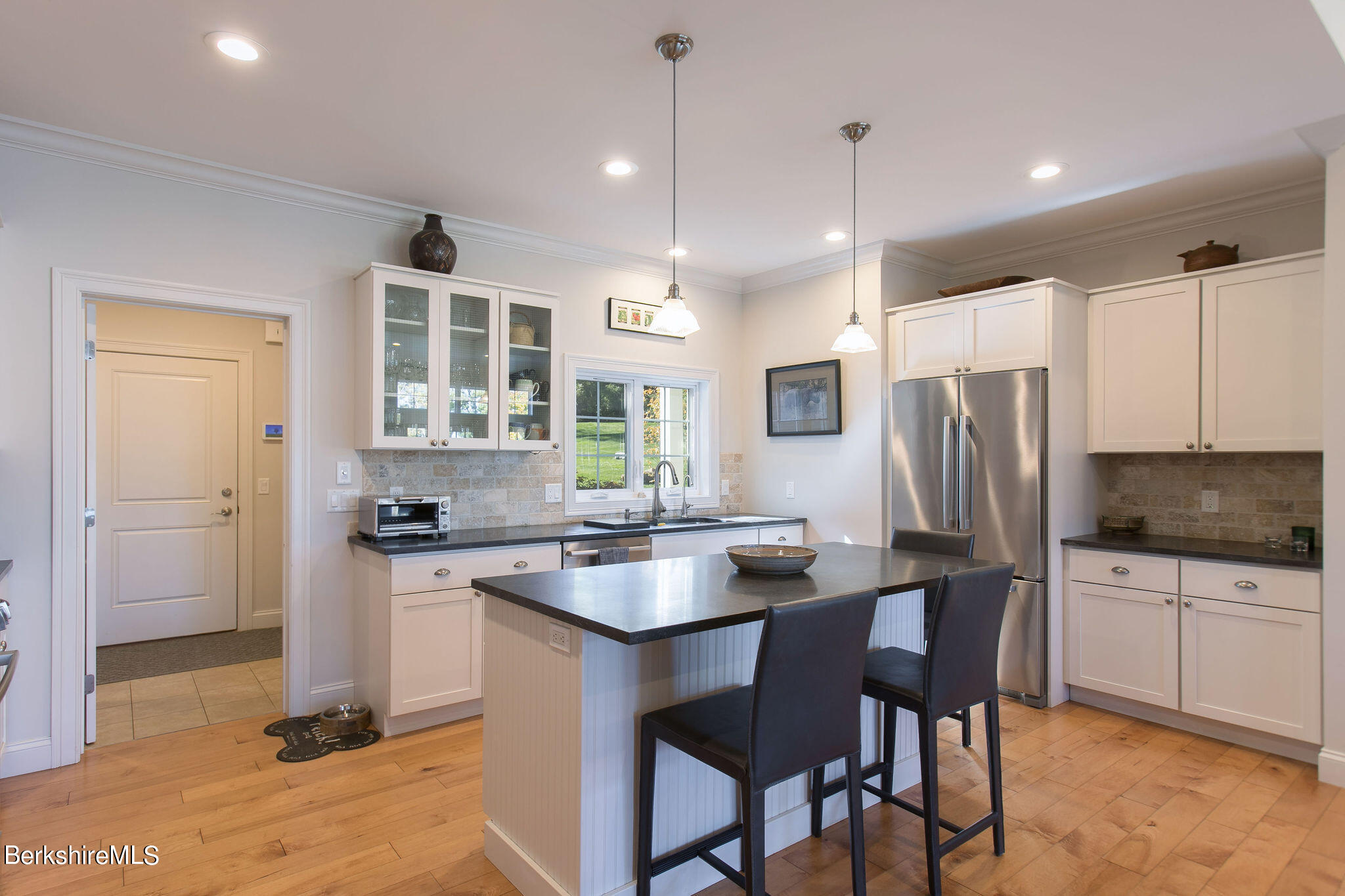19 Burning Tree Road Great Barrington, MA 01230 - Photo 10 of 33 a kitchen with refrigerator a sink and chairs