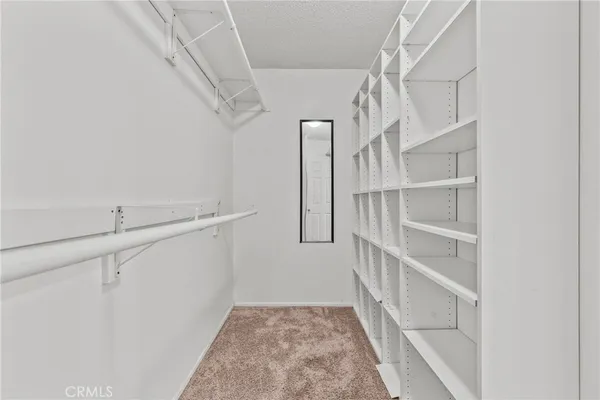 a view of staircase with white walls and a window