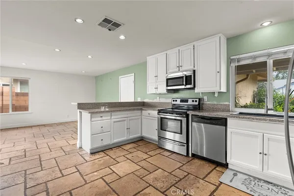 a kitchen with a stove a sink and a microwave