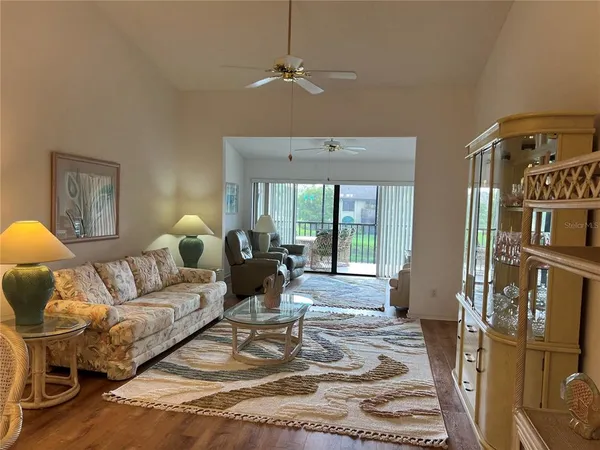 a living room with furniture fireplace and a window