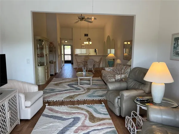 a living room with furniture and a lamp