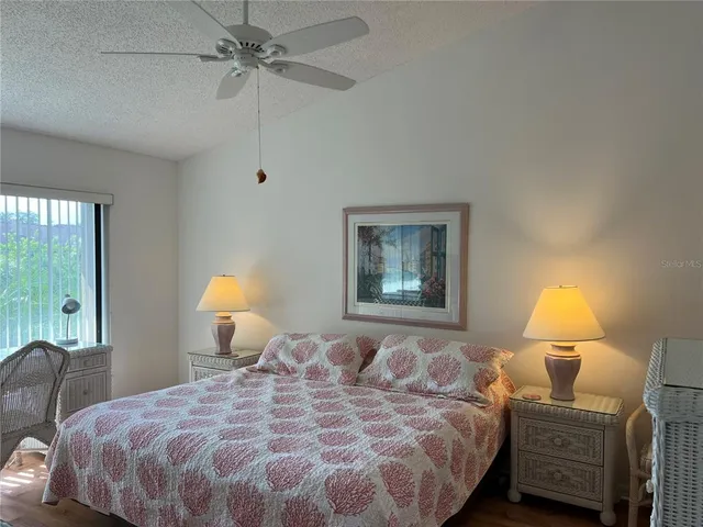 a bedroom with a bed and a lamp