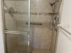 a bathroom with a glass shower door