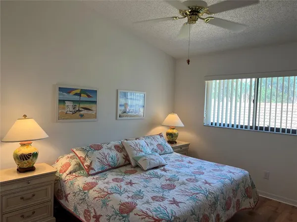 a bedroom with a bed and a lamp on dresser