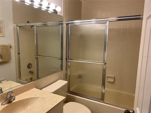 a bathroom with a shower and a sink